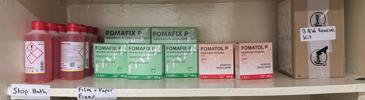 A shelf of Fomacitro stop bath bottles, Fomafix P fixer and Fomatol P developer boxes, and a black and white reversal kit