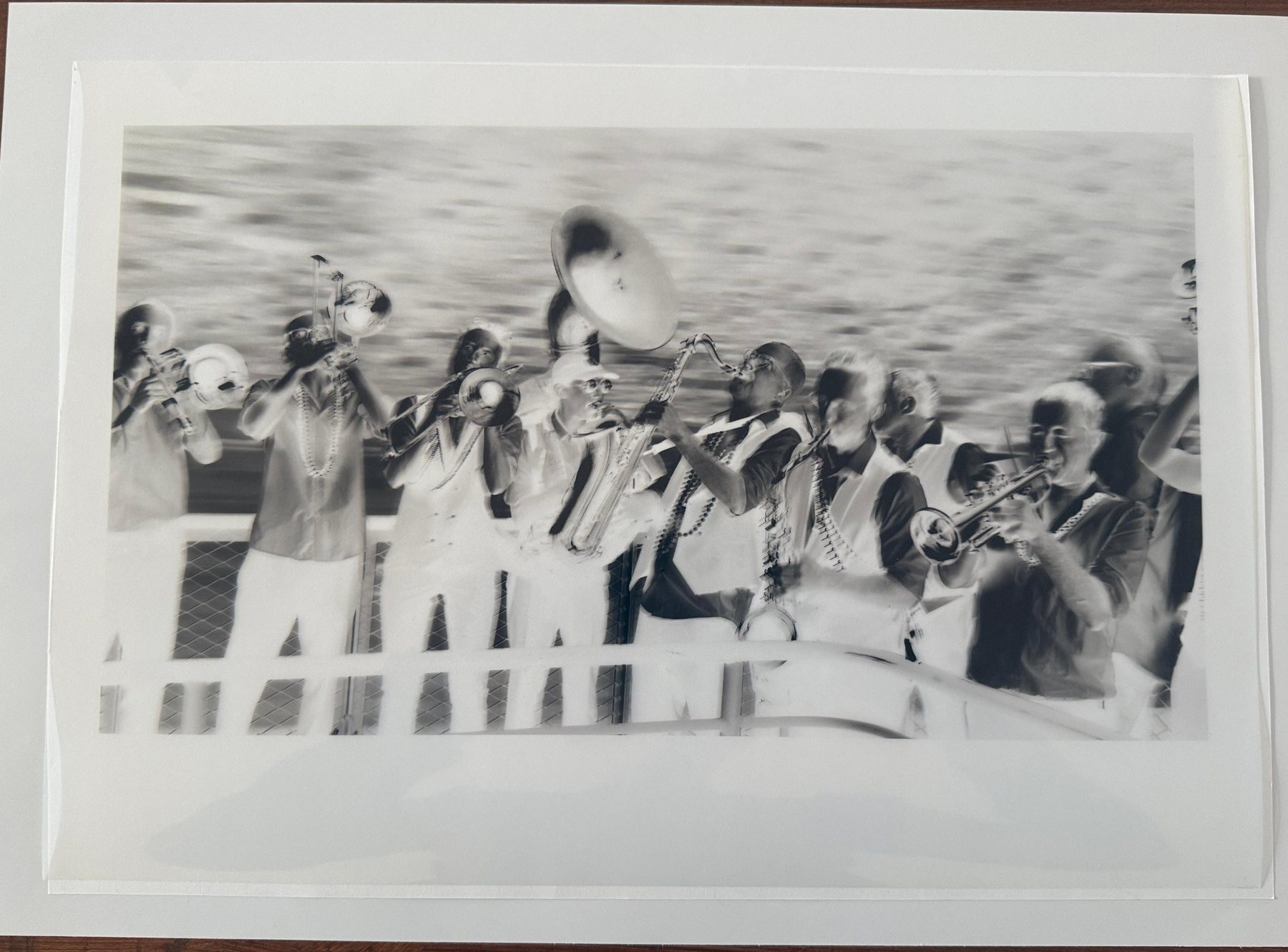A digital negative of a brass band on a clear sheet