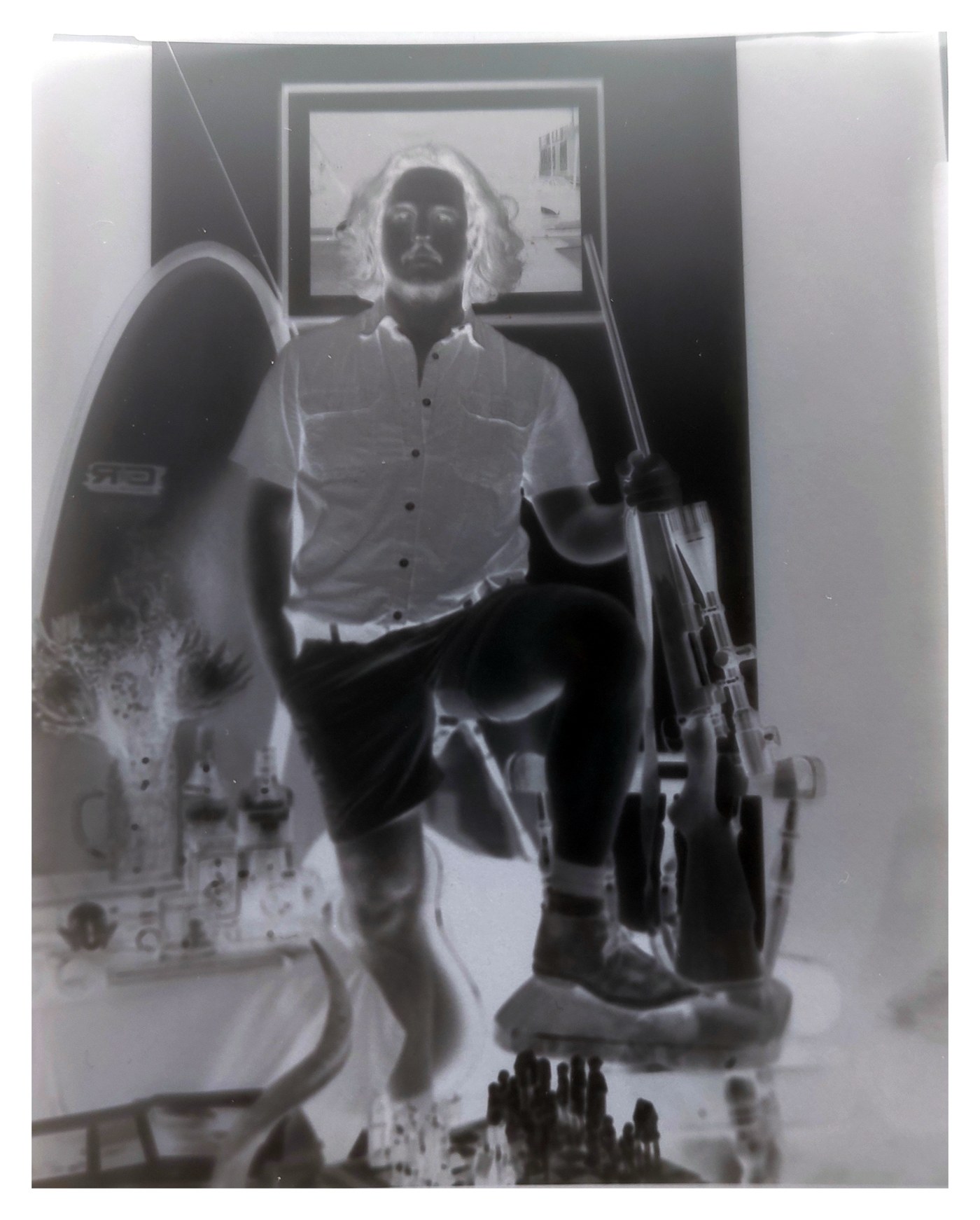 A 4x5 black and white portrait negative on a sheet of white paper